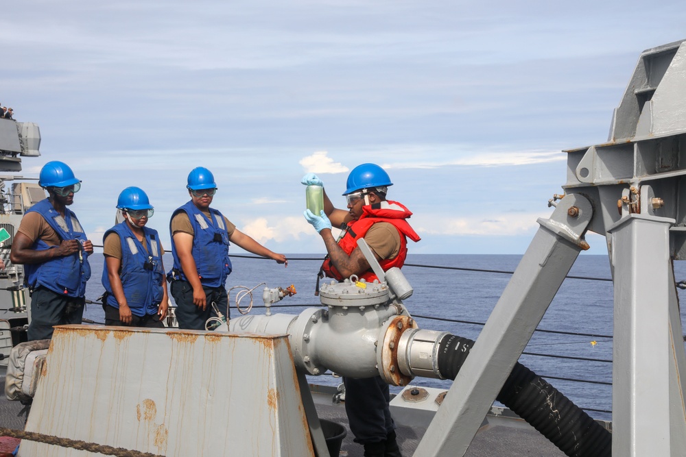 Sailors aboard the USS Howard conduct a replenishment-at-sea with the USNS Cesar Chavez in the South China Sea