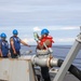 Sailors aboard the USS Howard conduct a replenishment-at-sea with the USNS Cesar Chavez in the South China Sea