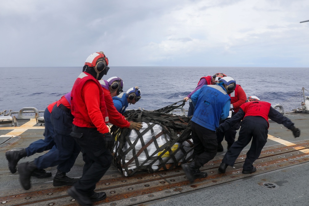 Sailors aboard the USS Howard conduct a replenishment-at-sea with the USNS Cesar Chavez in the South China Sea