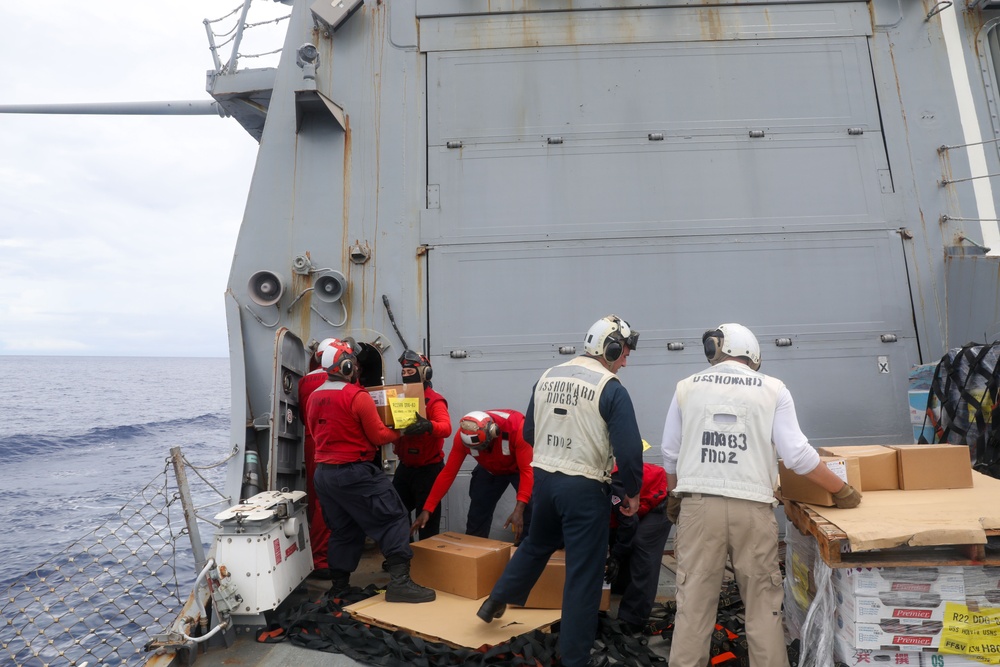 Sailors aboard the USS Howard conduct a replenishment-at-sea with the USNS Cesar Chavez in the South China Sea