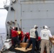 Sailors aboard the USS Howard conduct a replenishment-at-sea with the USNS Cesar Chavez in the South China Sea