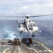 Sailors aboard the USS Howard conduct a replenishment-at-sea with the USNS Cesar Chavez in the South China Sea