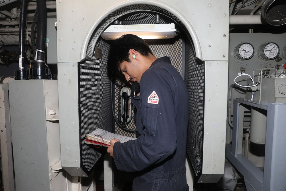 Sailors aboard the USS Howard conduct an engineering training team drill in the South China Sea