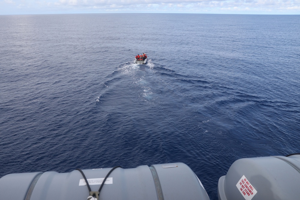 Sailors aboard the USS Howard conduct small boat operations in the South China Sea