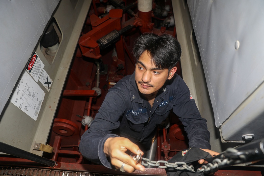 Sailors aboard the USS Howard conduct an engineering training team drill in the South China Sea