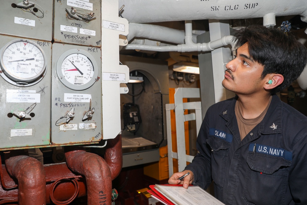 Sailors aboard the USS Howard conduct an engineering training team drill in the South China Sea