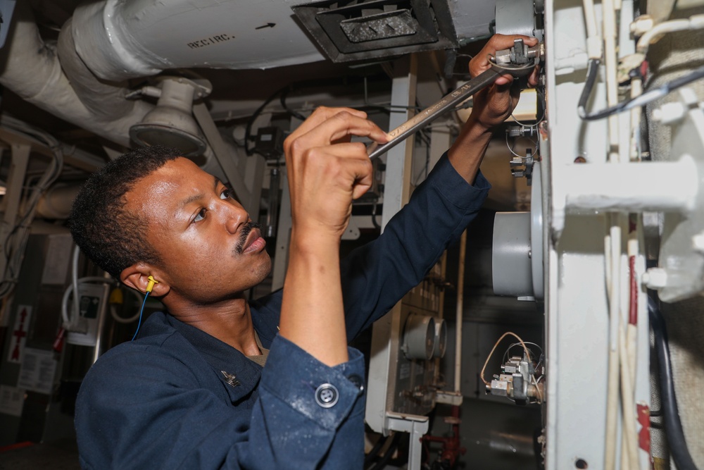 Sailors aboard the USS Howard conduct an engineering training team drill in the South China Sea