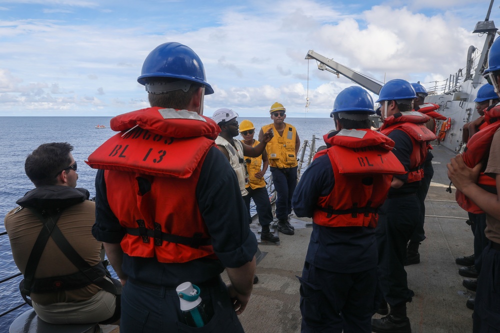 Sailors aboard the USS Howard conduct a small boat operations in the South China Sea