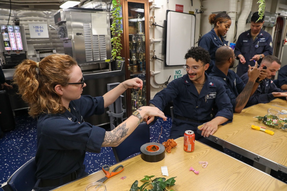 Sailors aboard the USS Howard host a friendship bracelet making event in the South China Sea