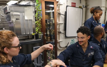 Sailors aboard the USS Howard host a friendship bracelet making event in the South China Sea