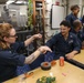 Sailors aboard the USS Howard host a friendship bracelet making event in the South China Sea