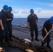 Sailors aboard the USS Howard conduct a sea and anchor detail in Okinawa, Japan