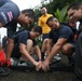 Sailors and Costa Rican medical professionals work side-by-side to build medical tents at the pier