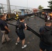 Sailors and Costa Rican medical professionals work side-by-side to build medical tents at the pier
