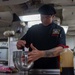 USS Ronald Reagan (CVN 76) Sailor prepares food