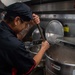 USS Ronald Reagan (CVN 76) Sailor prepares food