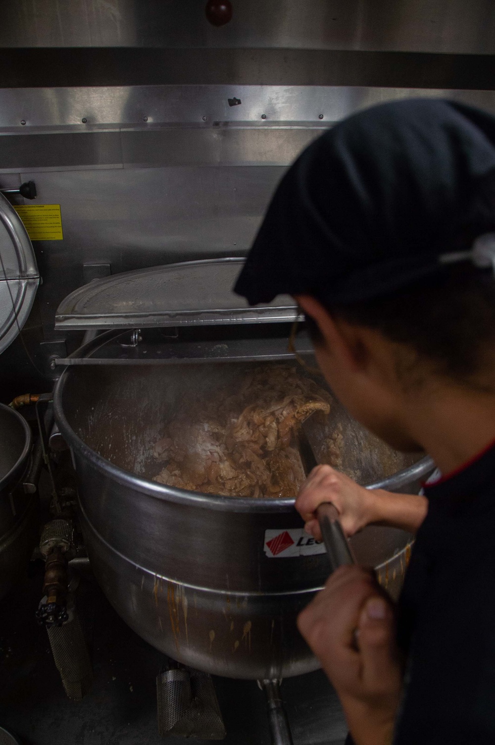 USS Ronald Reagan (CVN 76) Sailor prepares food