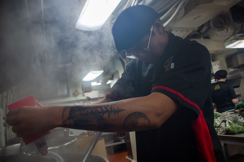 USS Ronald Reagan (CVN 76) Sailor prepares food