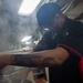 USS Ronald Reagan (CVN 76) Sailor prepares food