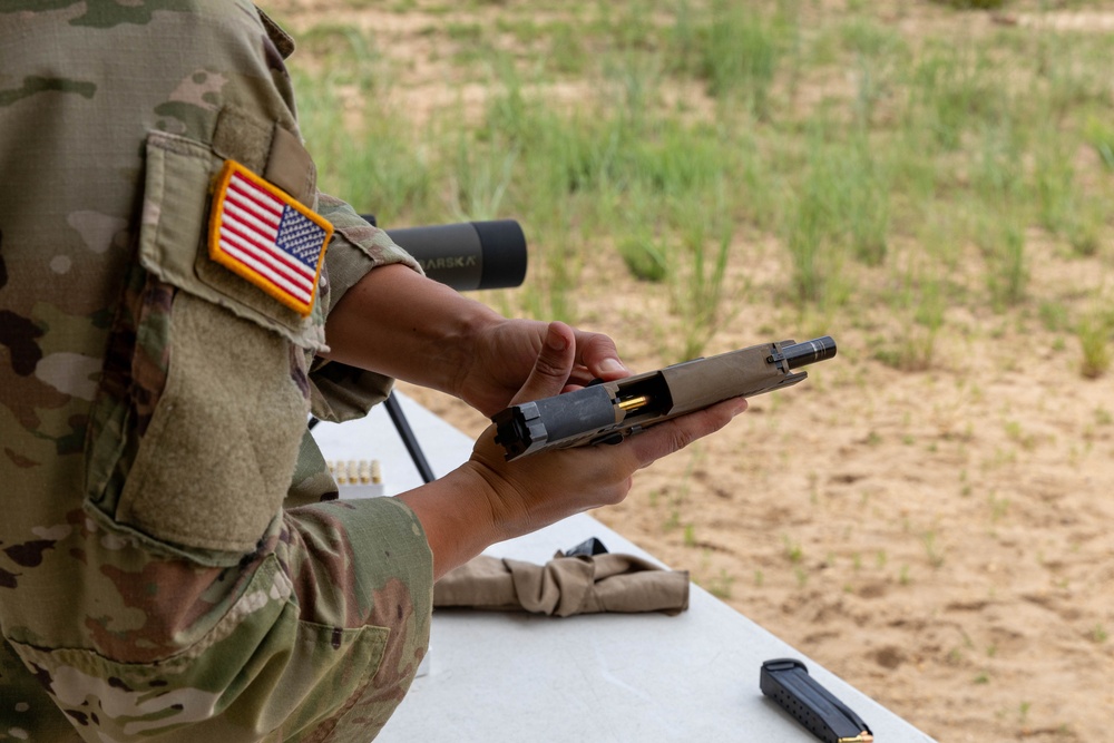 1st Lt. Brianna Mirmina loads her M17 pistol