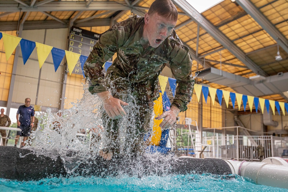 Sgt. Thomas Hunt jumps from a water obstacle