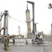 Naval Expeditionary Logistics Support Group and USS Chosin (CG 65) Guide a Missile Canister Using the U.S. Navy’s Transferrable Rearming Mechanism