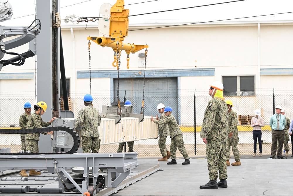 Naval Expeditionary Logistics Support Group and USS Chosin (CG 65) Guide a Missile Canister Using the U.S. Navy’s Transferrable Rearming Mechanism