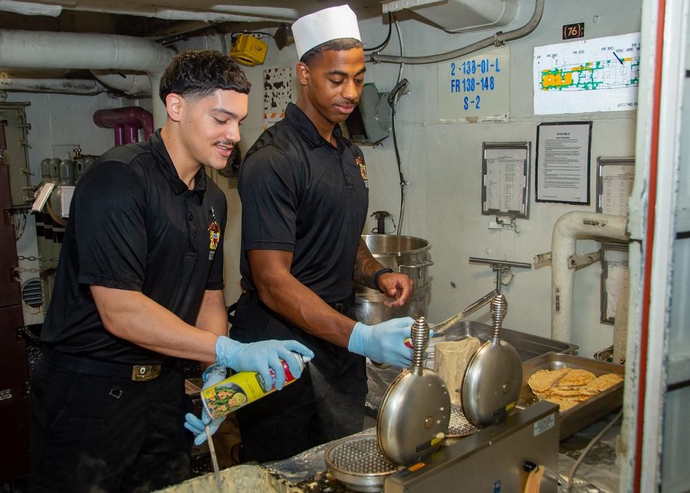USS Ronald Reagan (CVN 76) Sailors prepare food