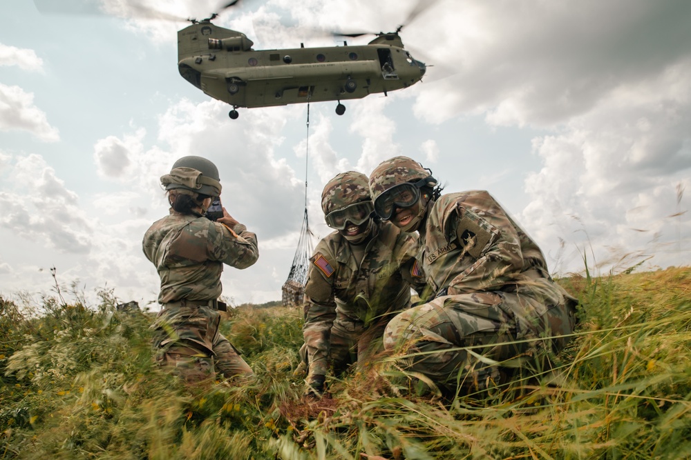 Two Iowa Army National Guard Soldiers smile for portrait following sling load exercise