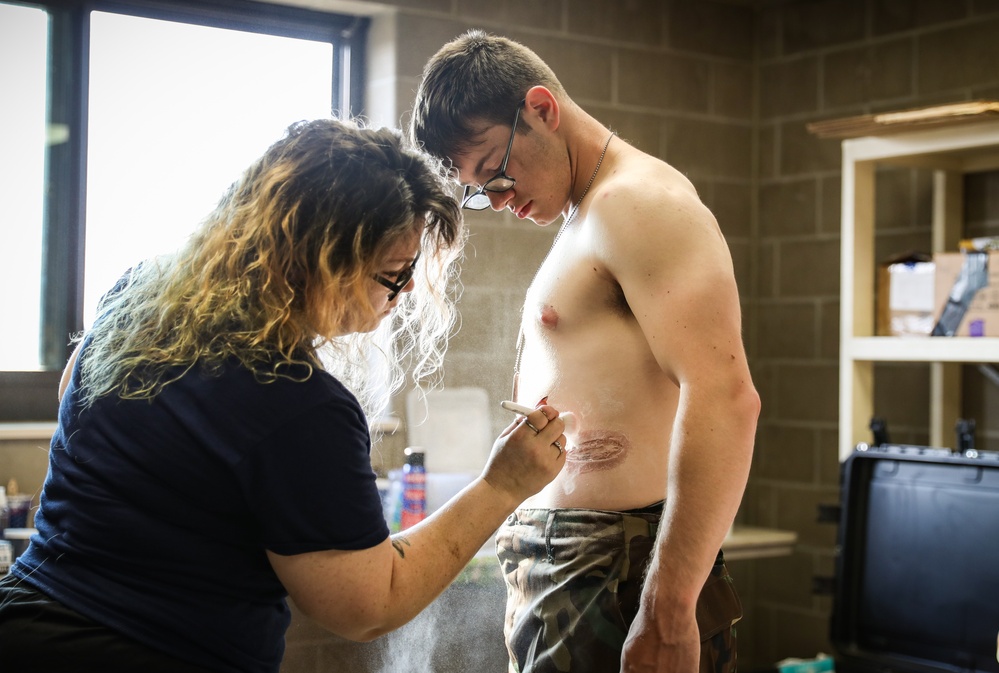 Special effects artist applies fake injuries to Iowa Soldier at XCTC