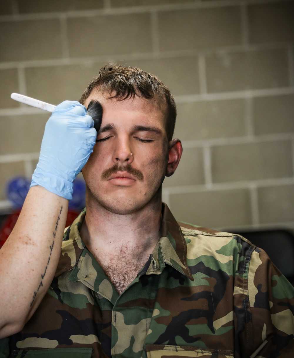 Special effects artist applies fake injuries to Iowa Soldier at XCTC