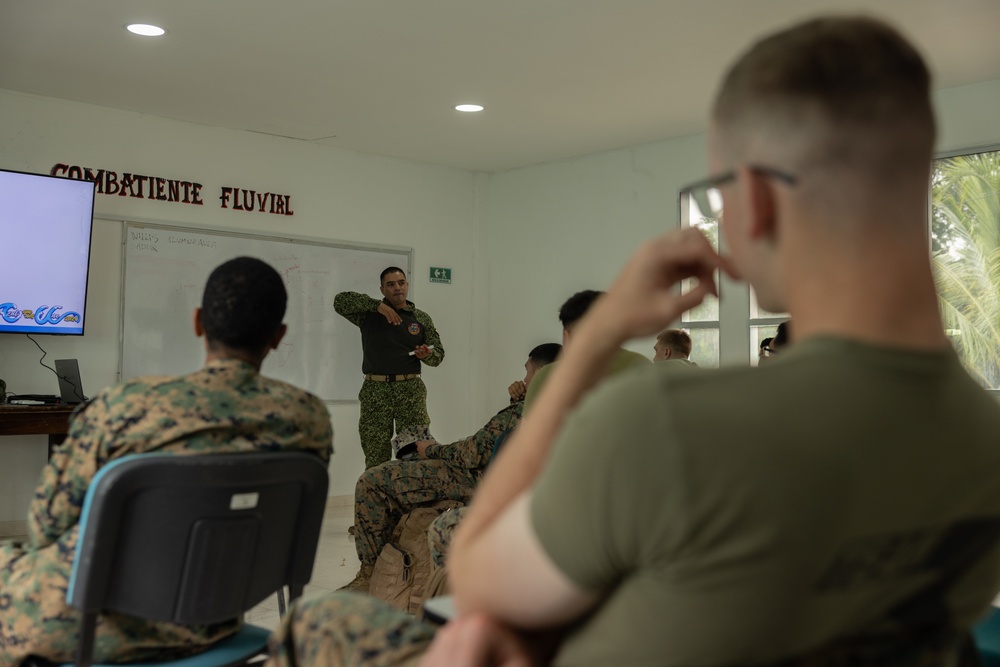 U.S. Marines with Littoral Craft Company Charlie learn about Colombian Marine Corps littoral crafts in a classroom setting.