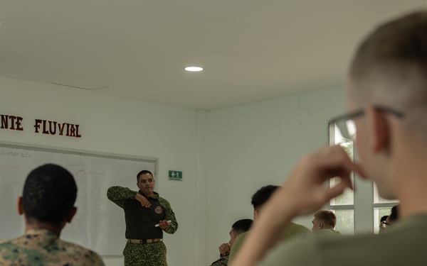U.S. Marines with Littoral Craft Company Charlie learn about Colombian Marine Corps littoral crafts in a classroom setting.