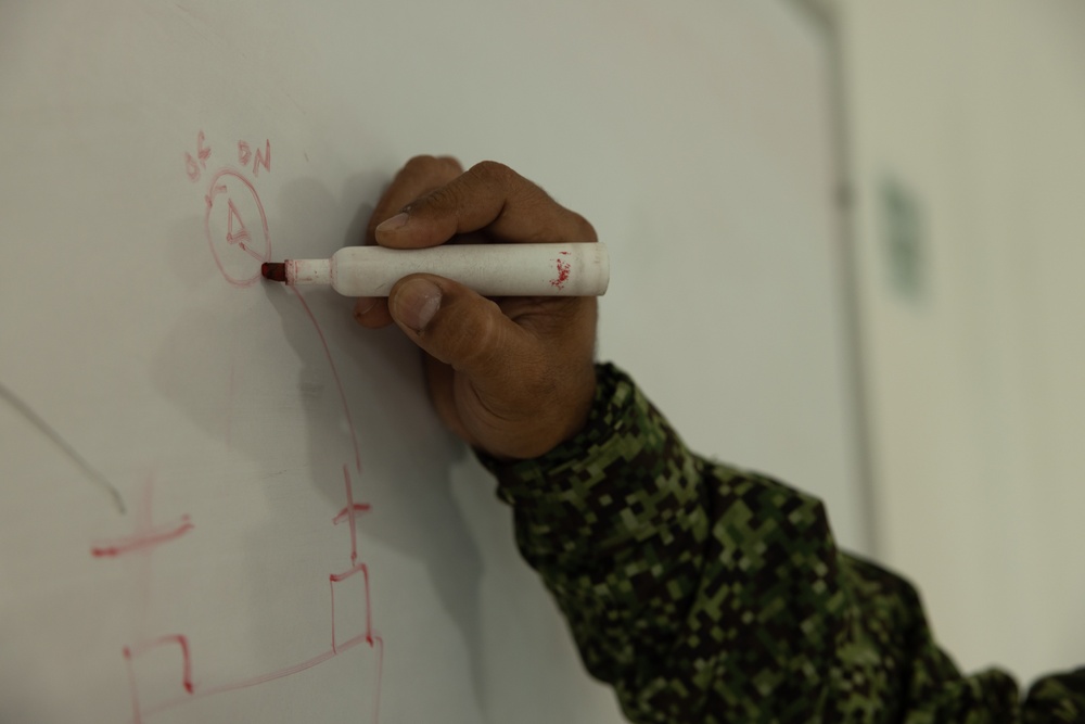 U.S. Marines with Littoral Craft Company Charlie learn about Colombian Marine Corps littoral crafts in a classroom setting.