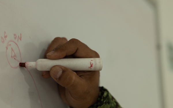 U.S. Marines with Littoral Craft Company Charlie learn about Colombian Marine Corps littoral crafts in a classroom setting.