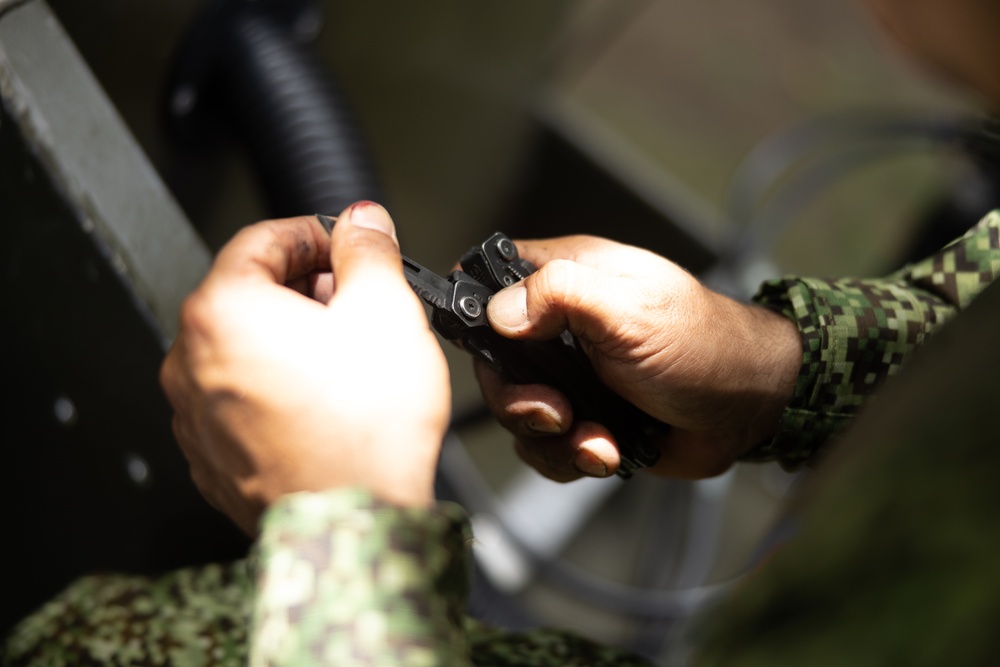 U.S. Marines with Littoral Craft Company Charlie learn about Colombian Marine Corps littoral crafts