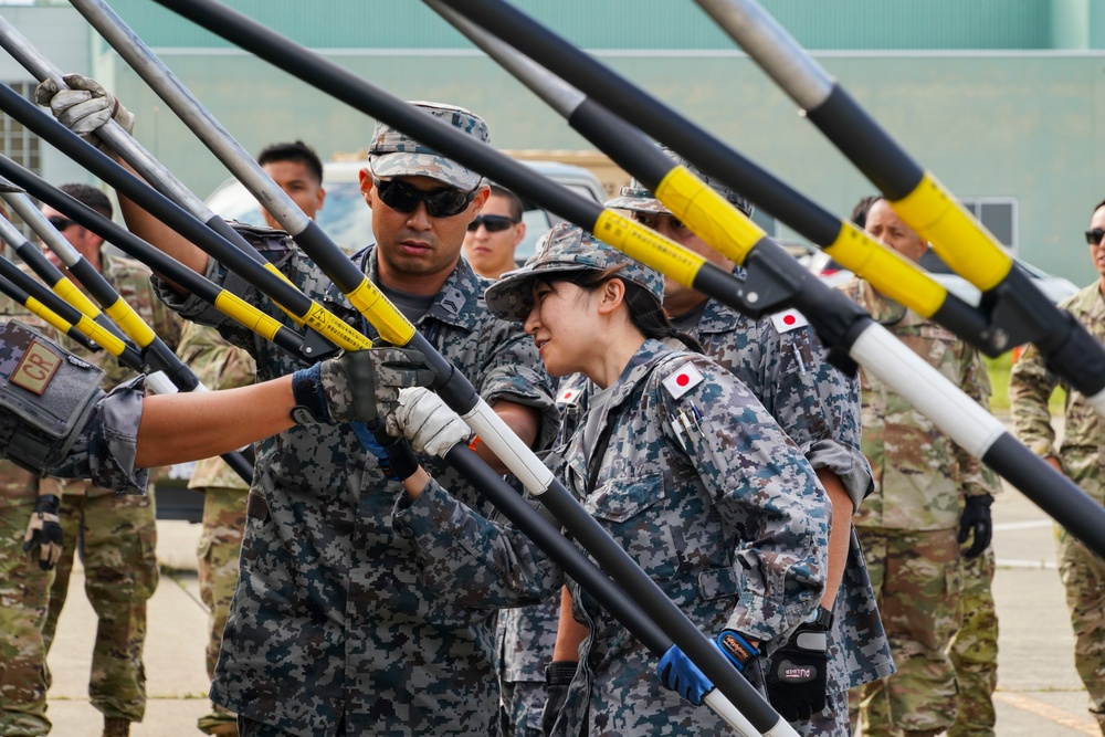 JASDF CR &amp; 146 CRT assist each other setting up equipment