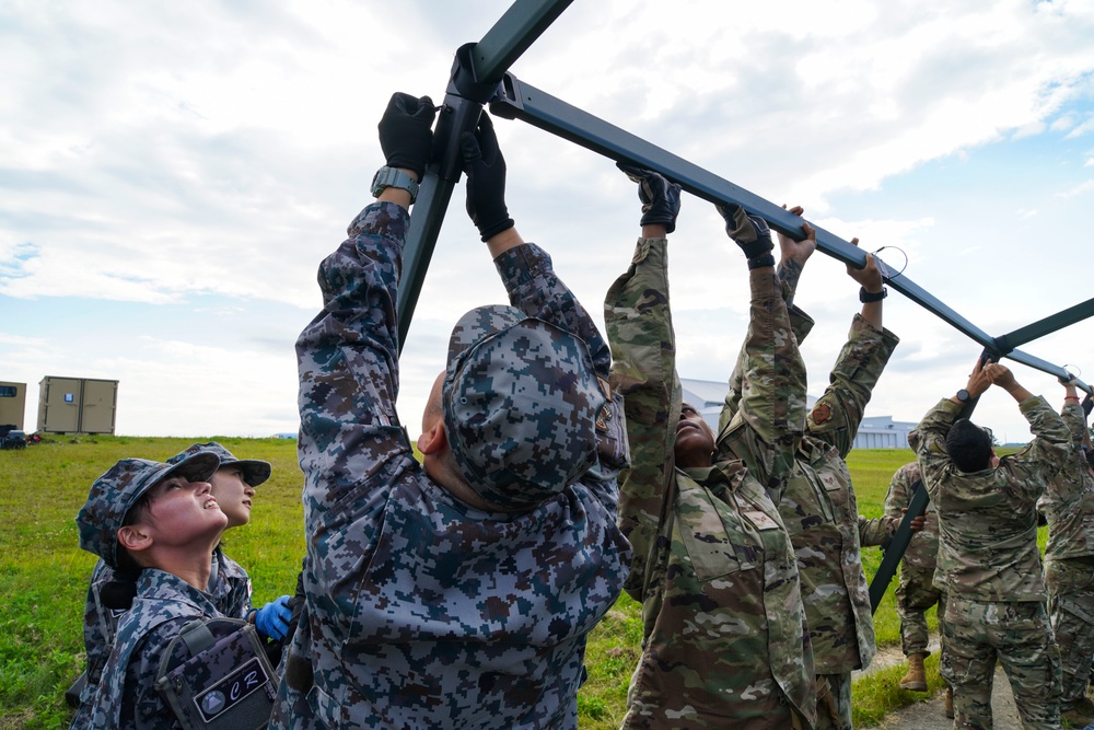 JASDF CR &amp; 146 CRT assist each other setting up equipment