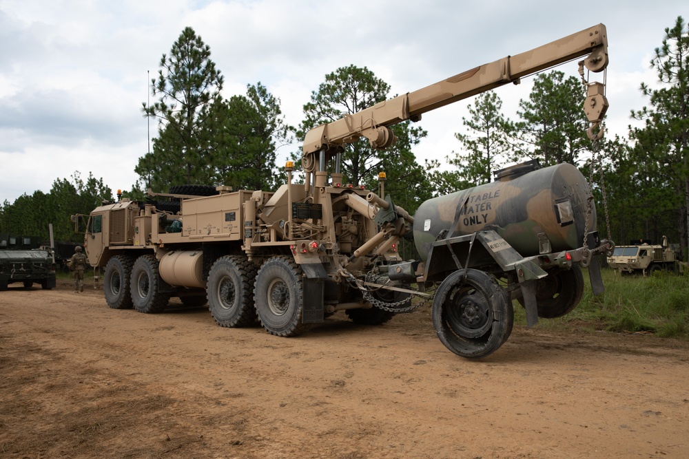 Wrecker tows damaged water tank trailer at JRTC 24-09