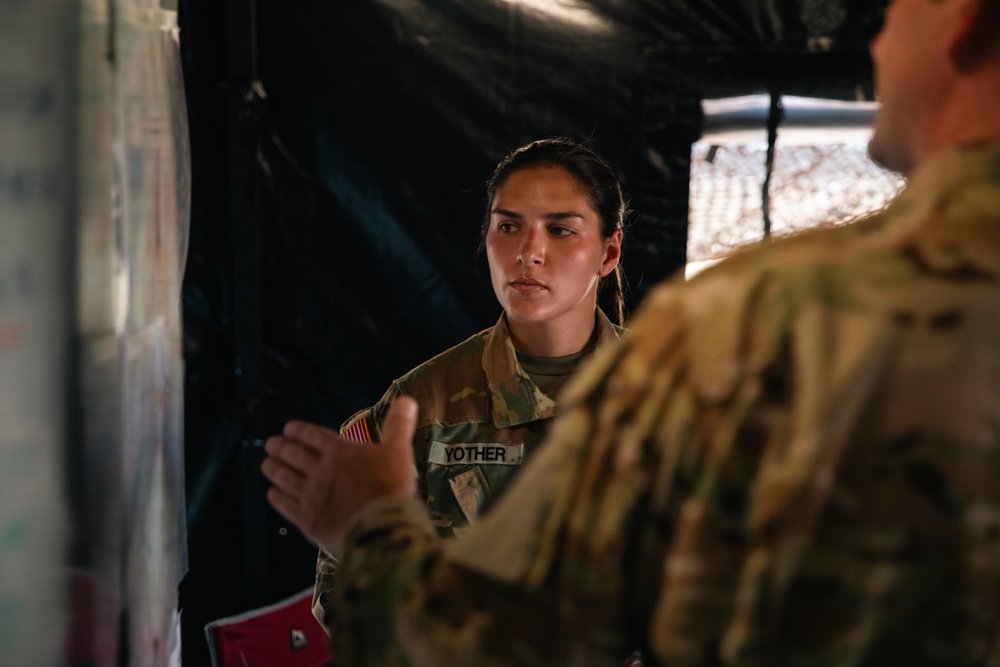 Apache helicopter pilot studies mission briefing information before exercise