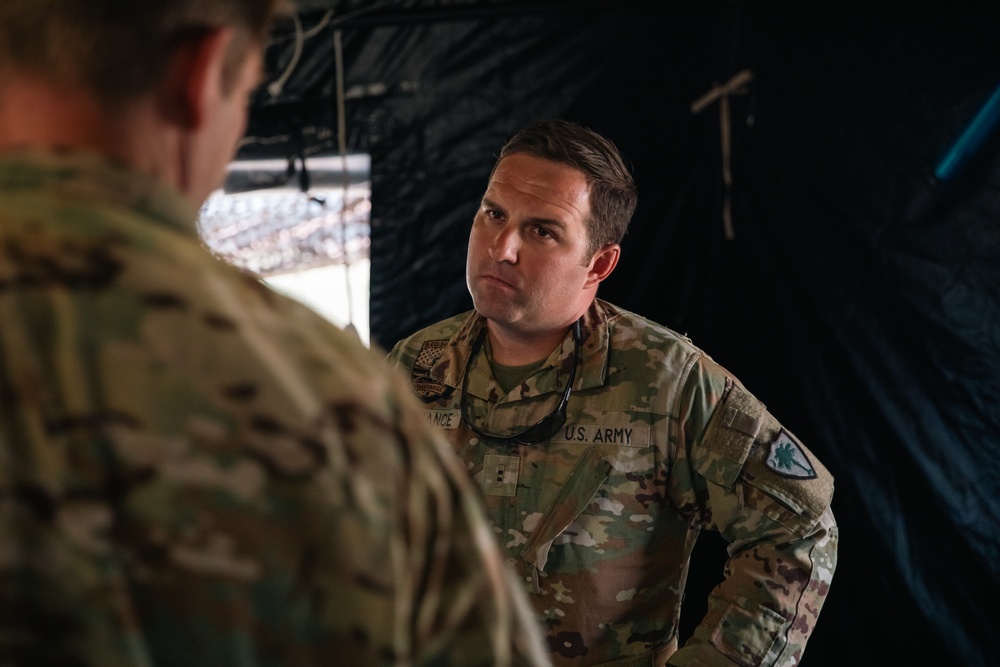 Apache helicopter pilot studies mission briefing information before exercise