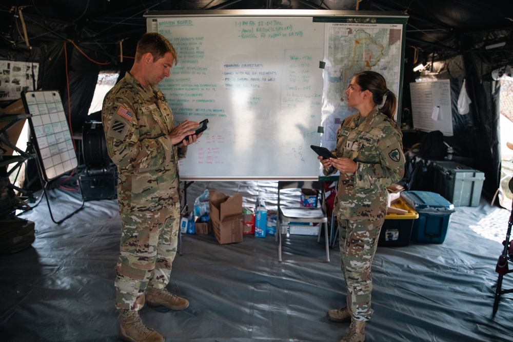 Apache pilots study flight information during mission briefing