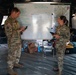 Apache pilots study flight information during mission briefing