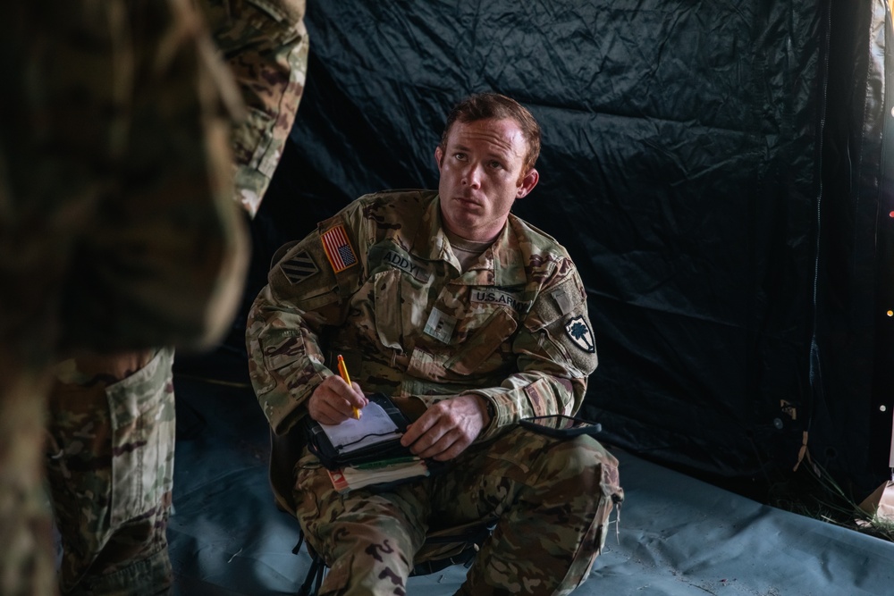 Apache helicopter pilot studies mission briefing information before exercise