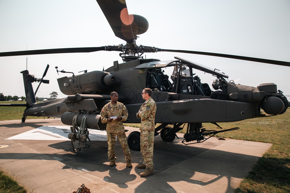 Apache helicopter pilots discuss safety briefing before flight