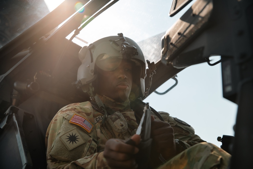 Apache helicopter pilot prepares cockpit prior to mission