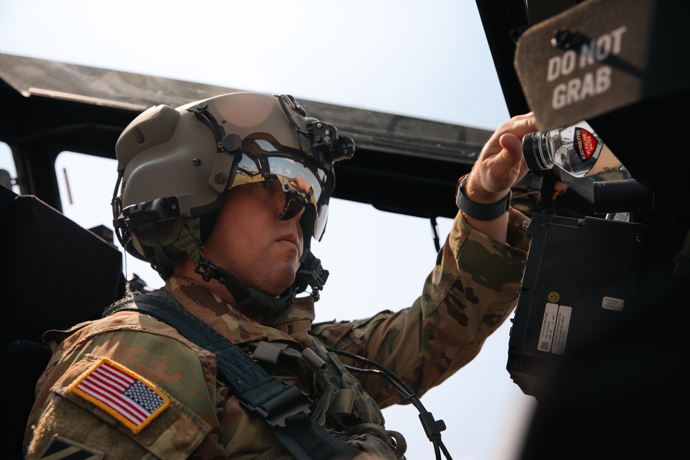 Apache helicopter pilot prepares cockpit before mission