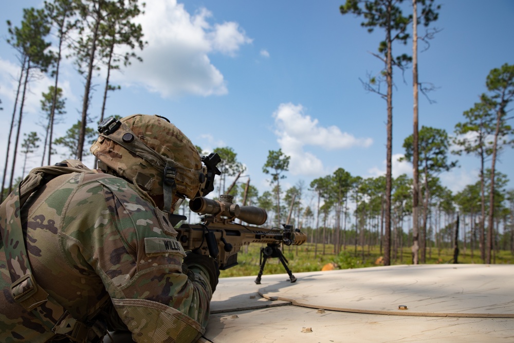 Scout holds security with a Barrett Mk22 Precision Sniper Rifle (PSR).