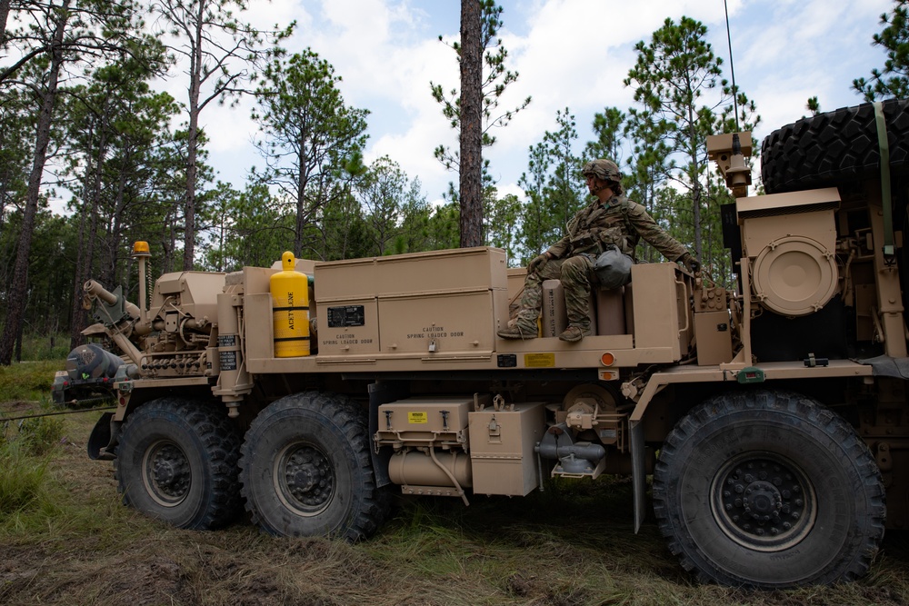 Wrecker operator controls winch during recovery operation