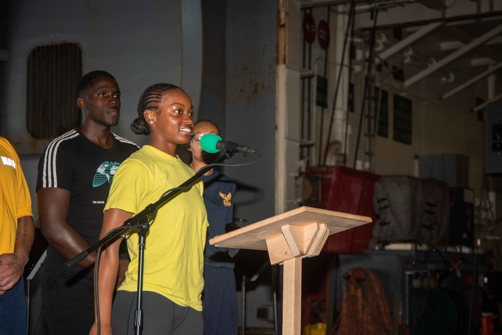 USS Ronald Reagan (CVN 76) Sailors hold a baptism in the Hangar Bay.